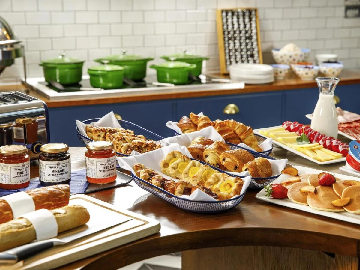 a table with many different types of pastries on it at Mercure Oxford Hawkwell House Hotel in Oxford