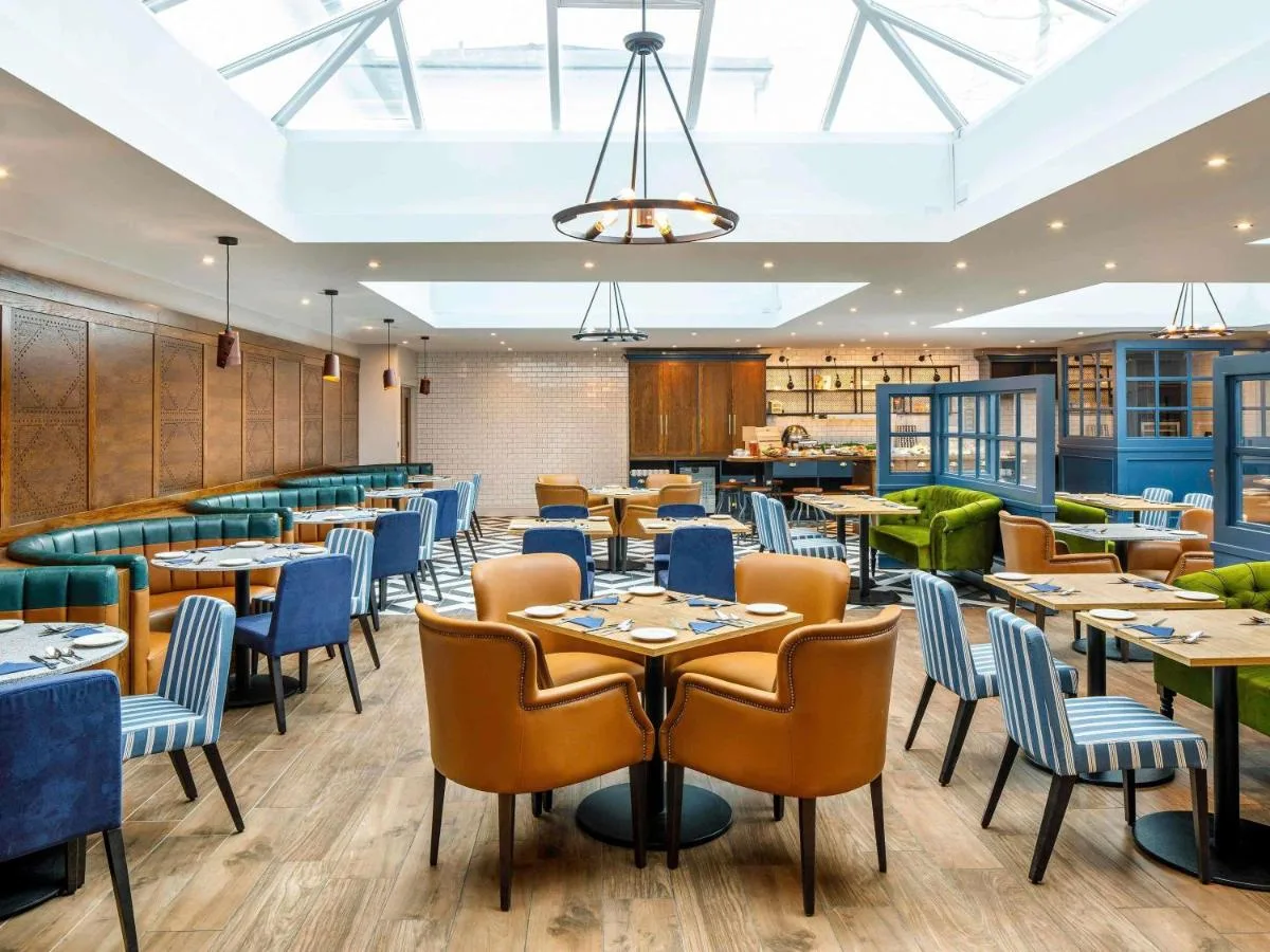 a dining room with tables and chairs at Mercure Oxford Hawkwell House Hotel in Oxford